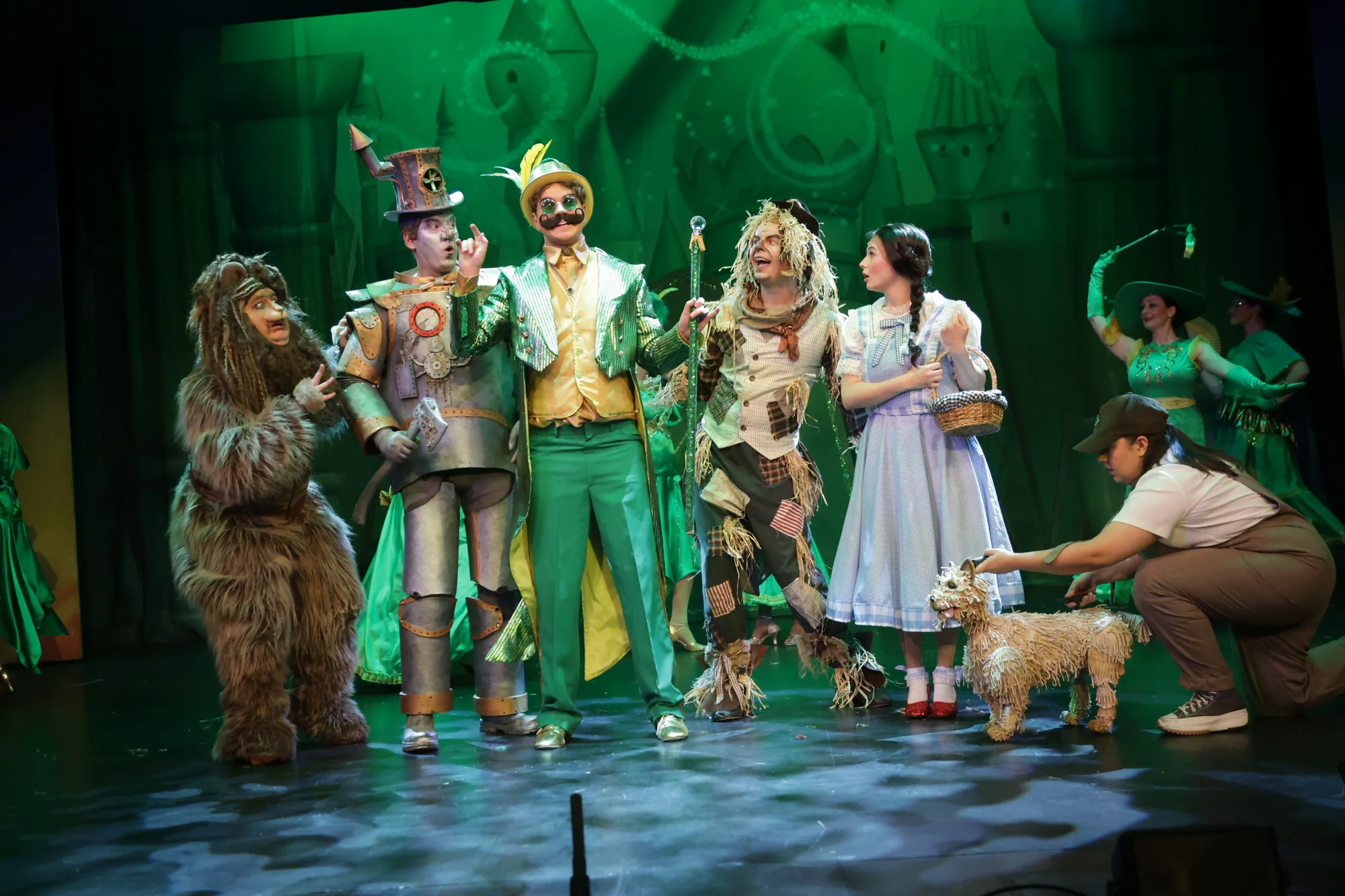 Dorothy, the Scarecrow, the Tin Man, the Cowardly Lion and the Wizard together under green light on the Dormston Mill Theatre stage in the company's 2025 production of The Wizard of Oz.